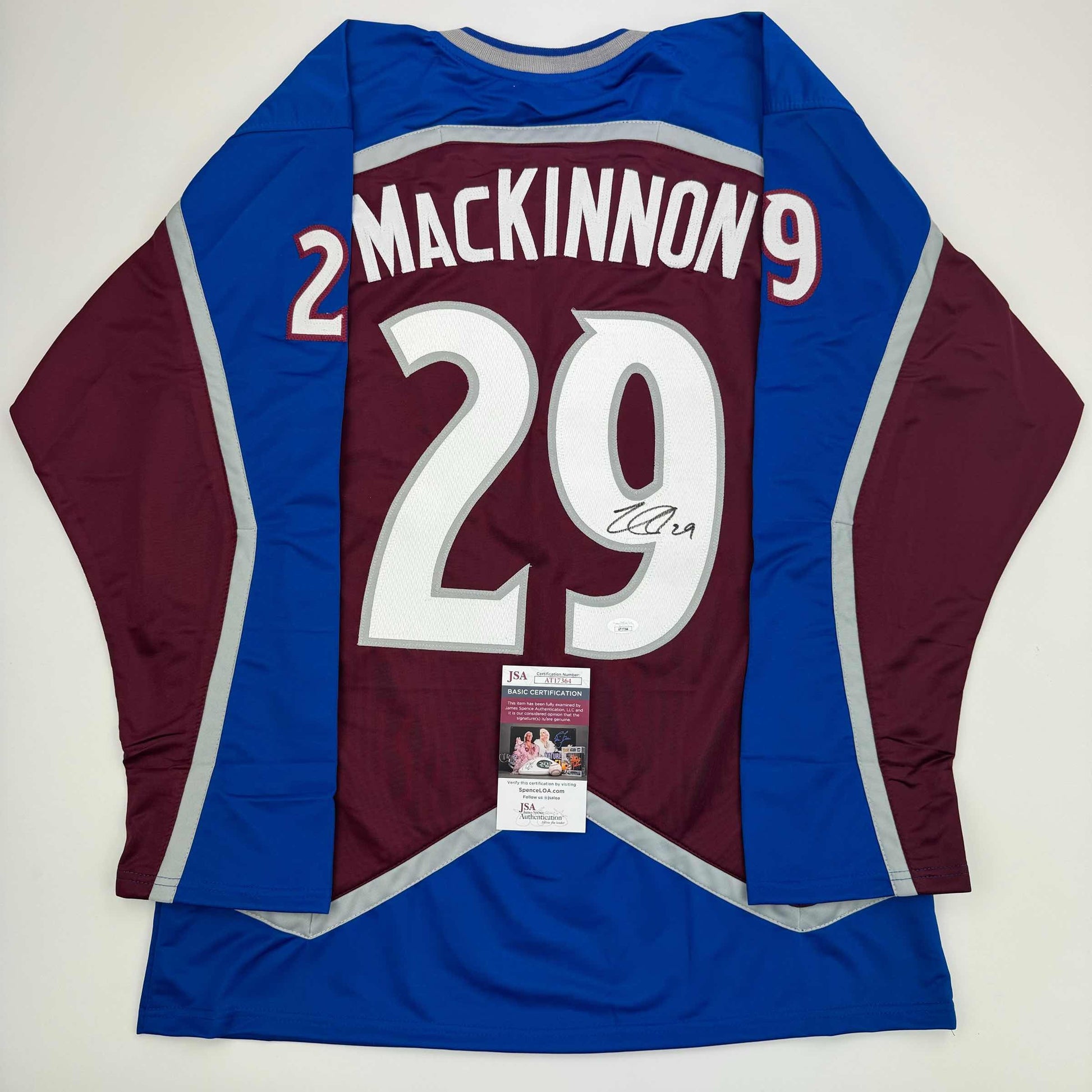 Back view of signed Nathan MacKinnon Colorado Avalanche maroon and blue hockey jersey with number 29 and JSA authentication certificate.