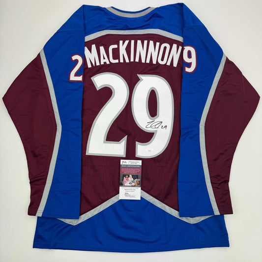 Back view of signed Nathan MacKinnon Colorado Avalanche maroon and blue hockey jersey with number 29 and JSA authentication certificate.