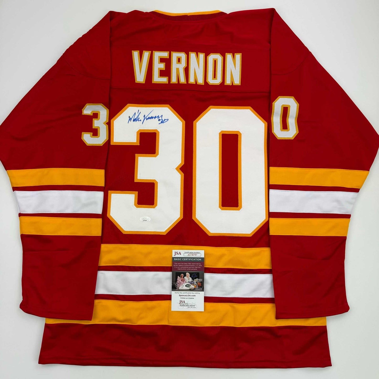 Red Calgary Flames hockey jersey with number 30, "VERNON" nameplate, autographed signature, and JSA certification sticker, displayed flat against white background.