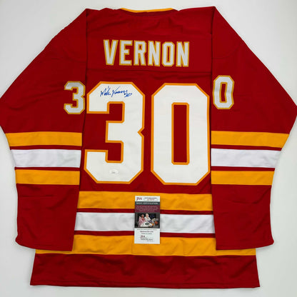 Red Calgary Flames hockey jersey with number 30, "VERNON" nameplate, autographed signature, and JSA certification sticker, displayed flat against white background.