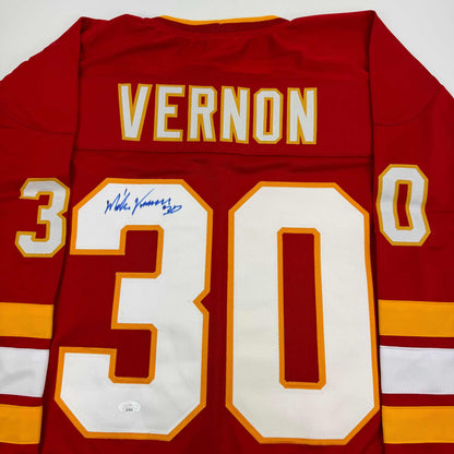 Red Calgary Flames hockey jersey with "VERNON" and number "30" displayed, featuring an autographed signature on the chest.