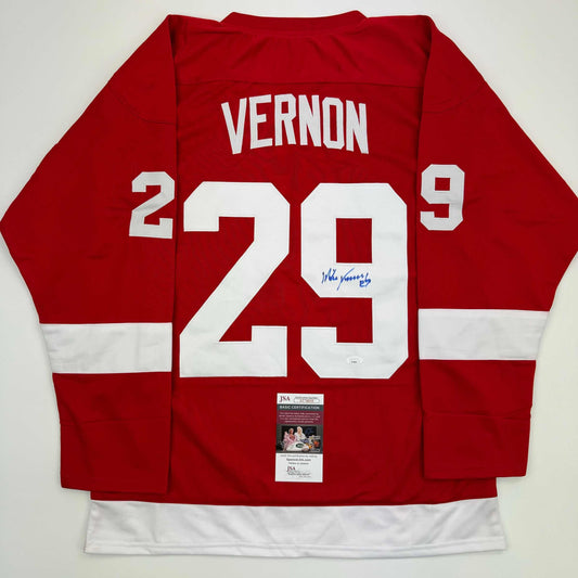 Red Detroit Red Wings hockey jersey with white number 29 and "VERNON" nameplate, displayed flat showing back with JSA authentication certificate.