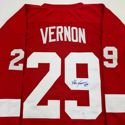 Red Detroit Red Wings jersey number 29 with "VERNON" printed across shoulders and blue autograph on white number.