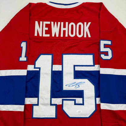 Red Montreal Canadiens hockey jersey displaying "NEWHOOK" and number 15 with signature on back view.