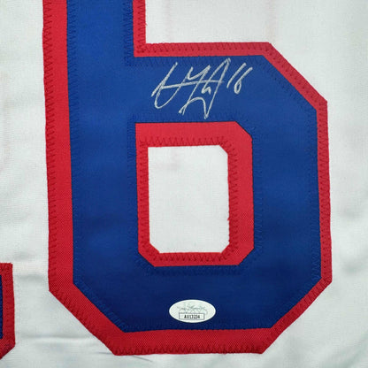 Close-up of blue jersey number 6 with red trim and handwritten autograph, showing JSA authentication sticker.