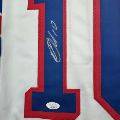 Close-up of signed blue stripe on white and red striped hockey jersey with JSA authentication sticker visible.