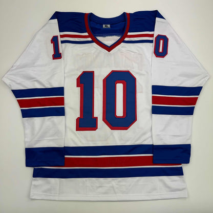 White hockey jersey with navy and red stripes, number 10 in navy and red, displayed flat against white background.