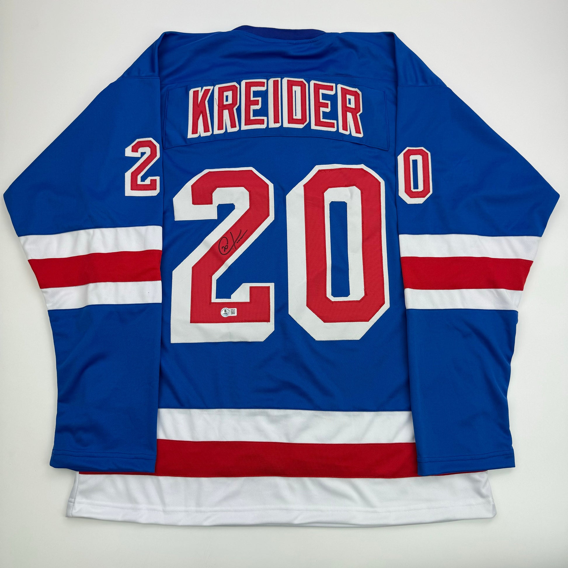 Back view of blue New York Rangers hockey jersey number 20 with Kreider name and autographed signature.