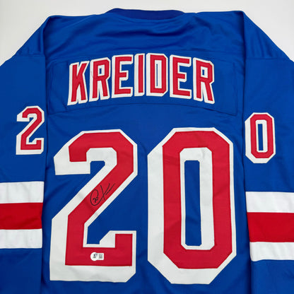 Blue New York Rangers hockey jersey with "KREIDER" and number 20 displayed on back, featuring red and white stripes, with visible autograph on the number.
