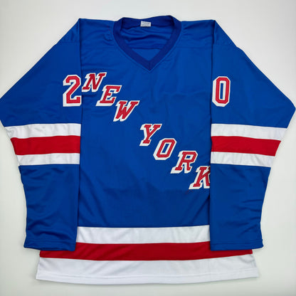 Blue New York Rangers hockey jersey with red and white striped sleeves, displaying "2NEW YORK" and "0" text, laid flat on white background.
