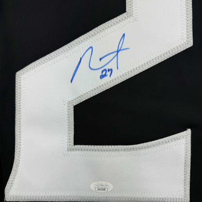 Close-up of white jersey collar showing blue autograph reading "Alec" with "#27" and JSA authentication label at bottom.