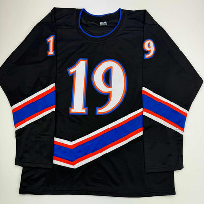Black hockey jersey with blue and red striped sleeves, large white number 19 with blue and red outline on chest, small numbers 1 and 9 on shoulders, displayed flat from front.