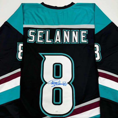 Back view of black hockey jersey with turquoise and white trim, displaying "SELANNE" and number 80 with blue autograph signature.