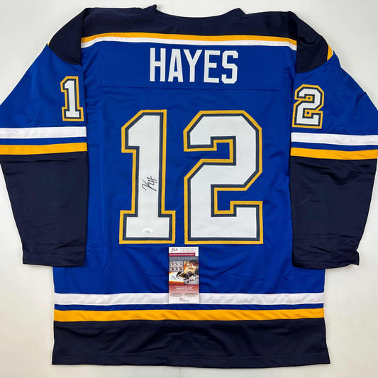 Back view of blue St. Louis Blues hockey jersey number 12 with Hayes name and JSA authentication certificate visible.