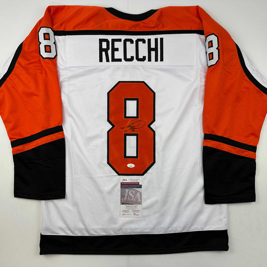 Back view of white Philadelphia Flyers hockey jersey number 8 with "RECCHI" nameplate and signature, orange and black sleeves, JSA authentication sticker visible.