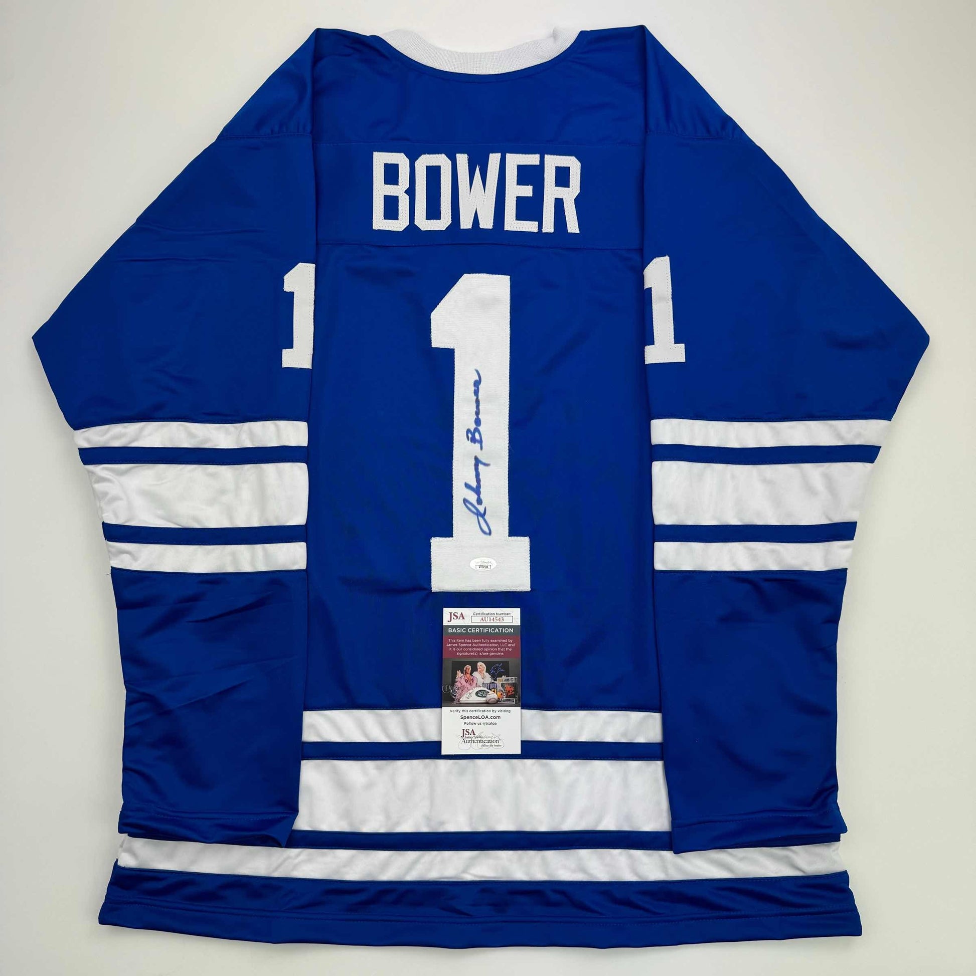 Back view of signed blue and white Toronto Maple Leafs hockey jersey number 1 with Bower name and JSA authentication certificate.