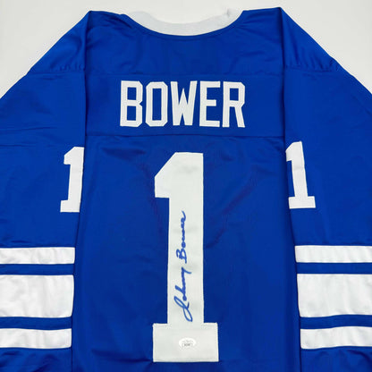 Back view of blue Toronto Maple Leafs jersey number 1 with "BOWER" nameplate and autographed signature on white number.