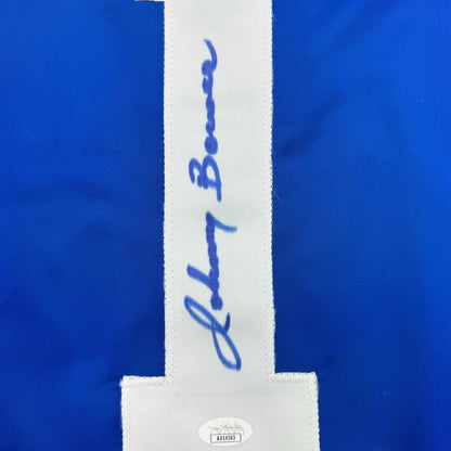 Close-up of white center stripe on blue jersey showing blue handwritten signature and JSA authentication label.