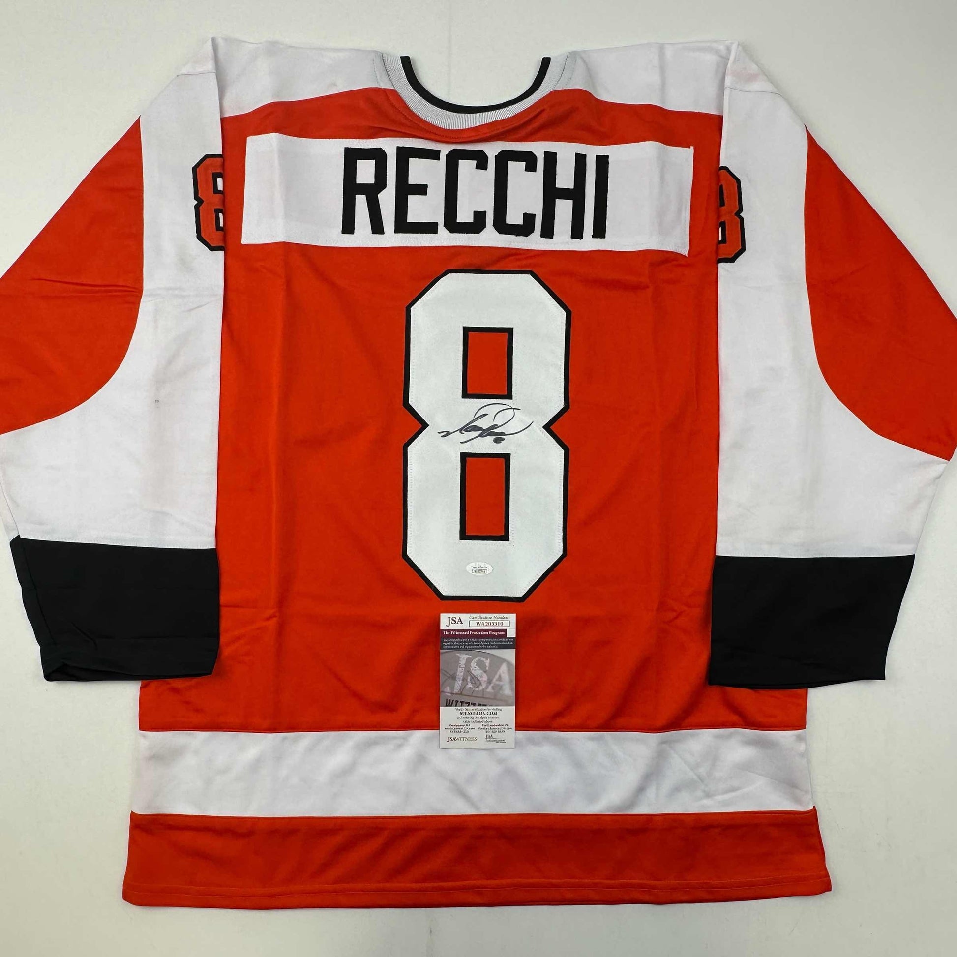 Signed Philadelphia Flyers hockey jersey number 8 with Recchi name displayed flat, showing red, white, and black striped design with JSA authentication certificate.