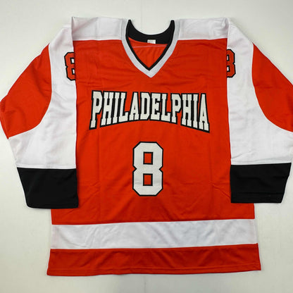 Red, white, and black Philadelphia hockey jersey number 8 laid flat against white background, front view.