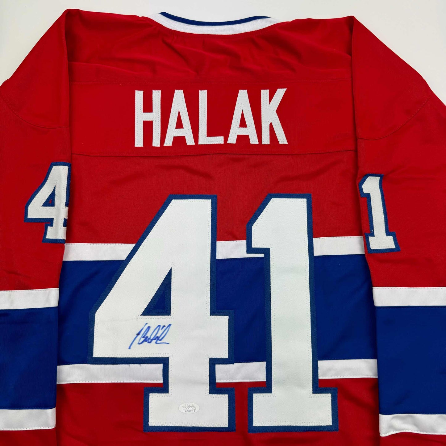 Back view of signed red, white, and blue Montreal Canadiens jersey number 41 with "HALAK" nameplate.