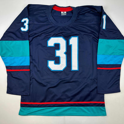 Navy blue hockey jersey number 31 with cyan and red striping, displayed flat lay from front view.