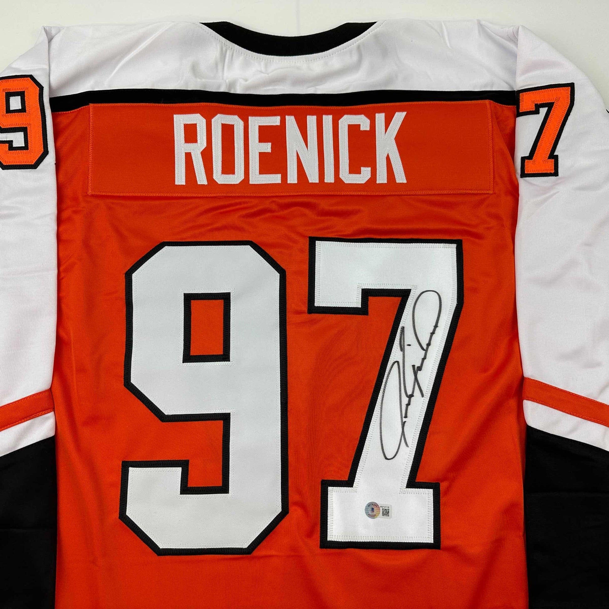 Back view of signed orange Philadelphia Roenick hockey jersey displaying number 97 with white numerals and black outline.
