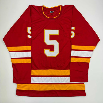 Red hockey jersey with white number 5 and gold/yellow trim, displayed flat against white background, front view.