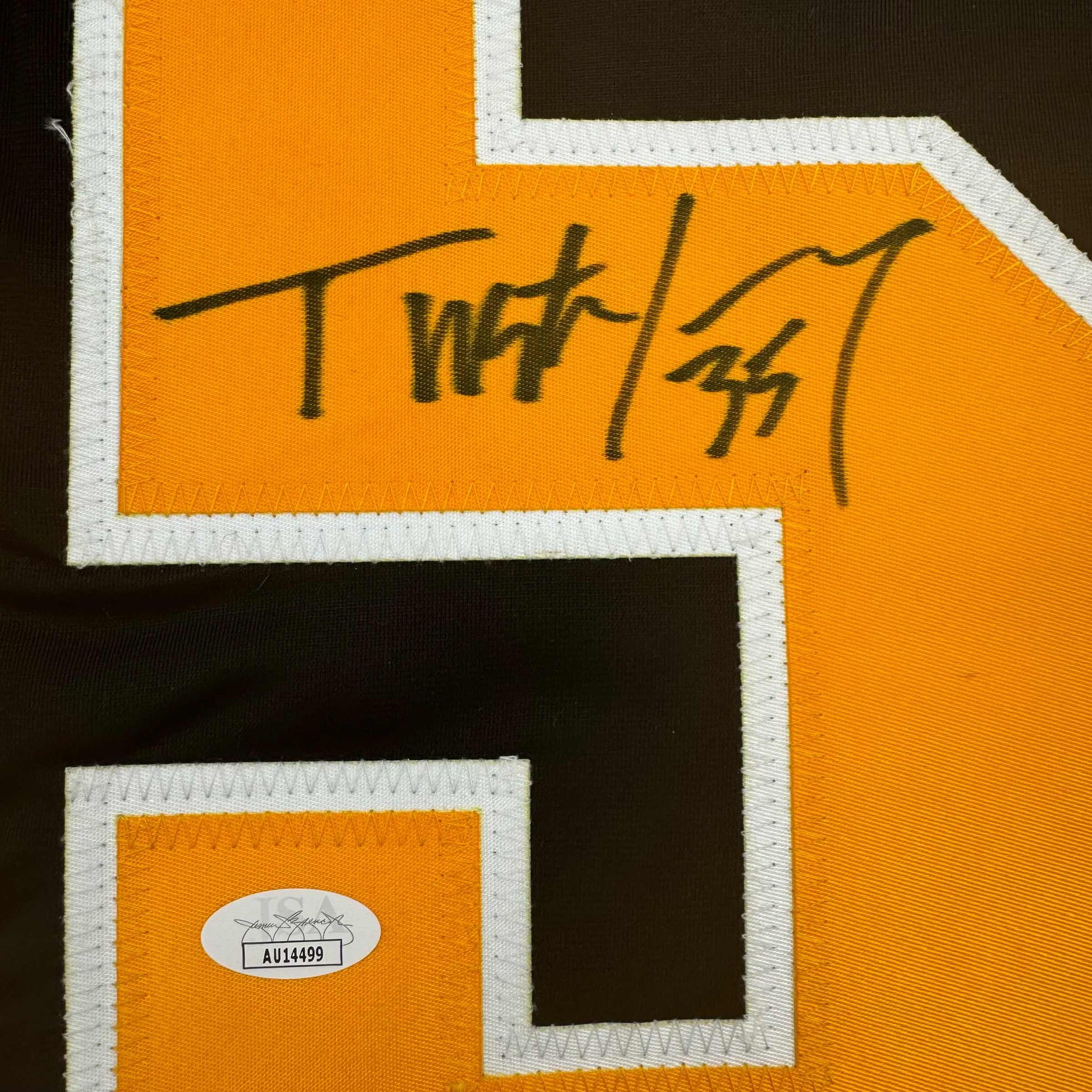 Close-up of handwritten signature "Tristan Jarry" on orange hockey jersey with white trim and JSA authentication sticker.