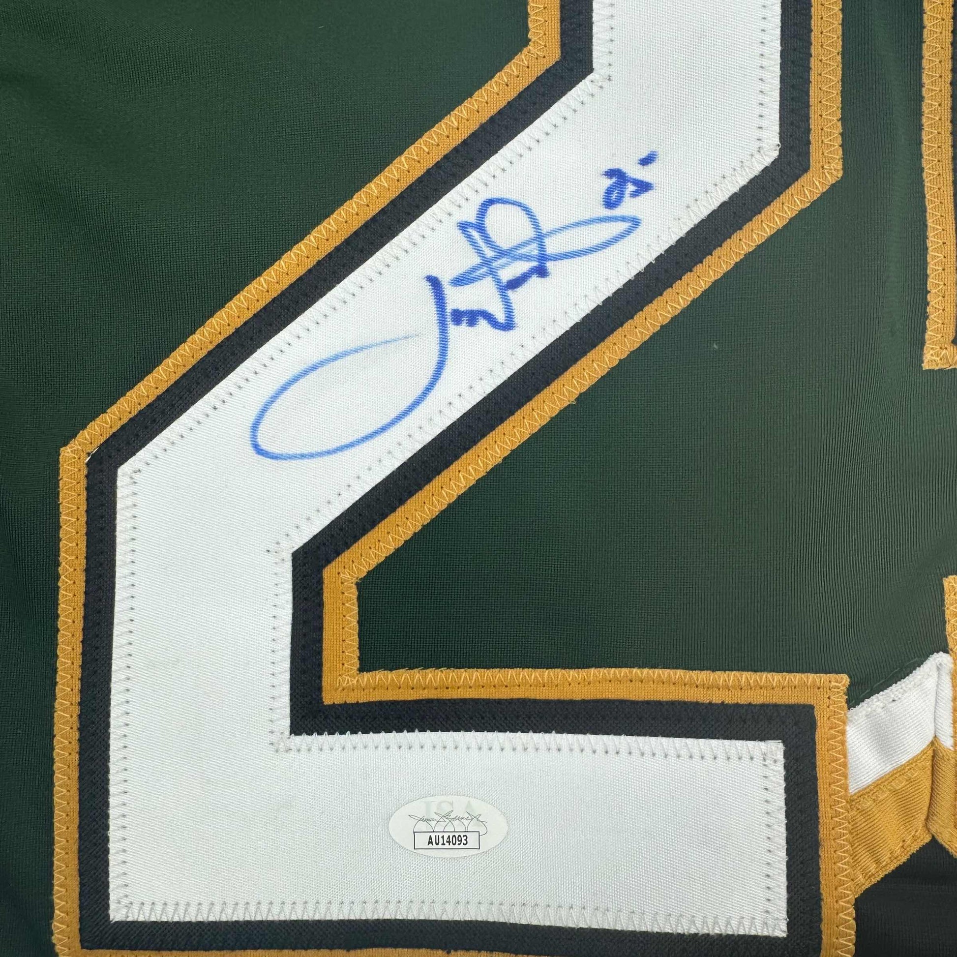 Close-up of signed Dallas Stars green jersey nameplate with blue autograph and JSA authentication sticker visible.
