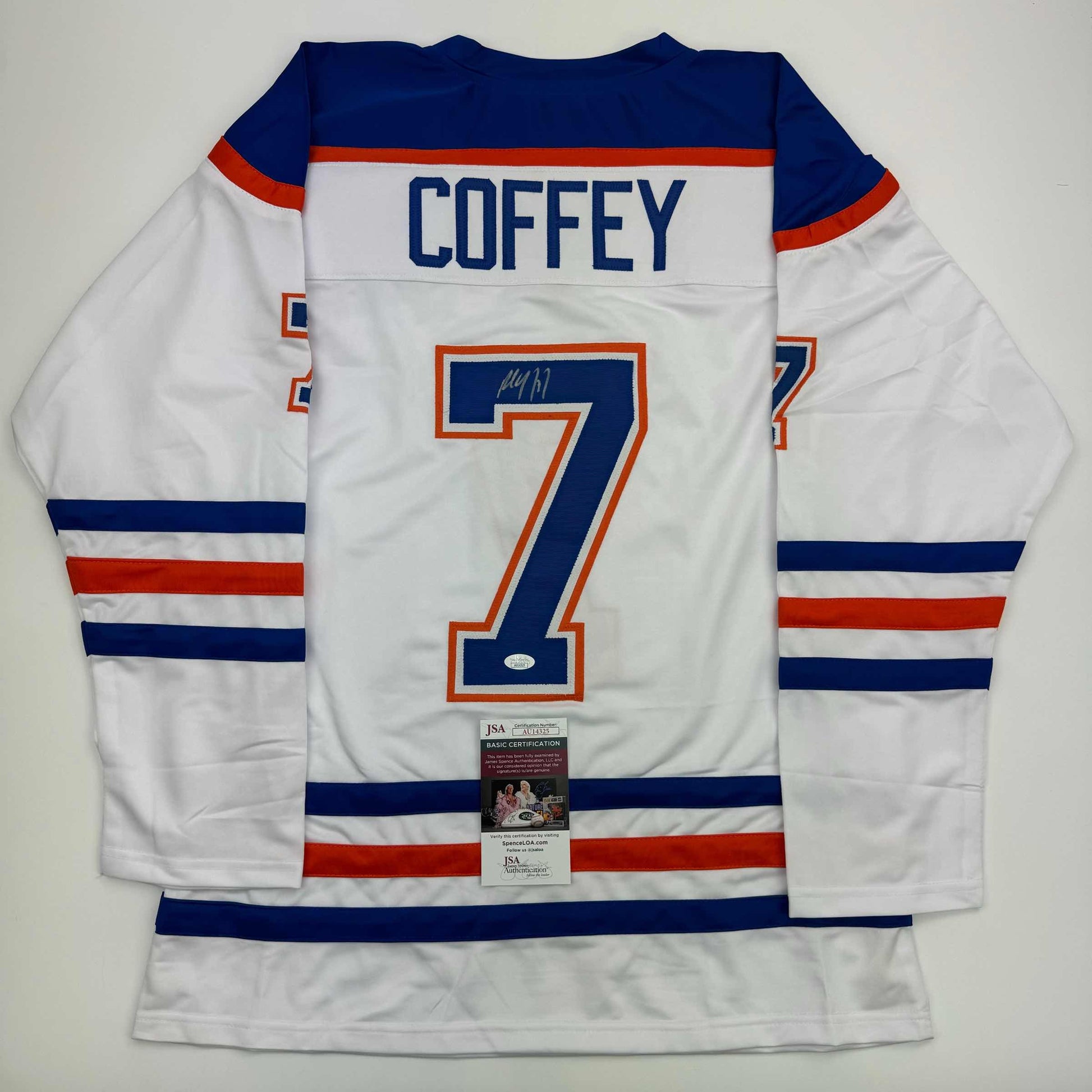 Back view of white Edmonton Oilers hockey jersey number 7 signed by Paul Coffey with JSA authentication certificate.