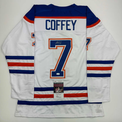 Back view of white Edmonton Oilers hockey jersey number 7 signed by Paul Coffey with JSA authentication certificate.