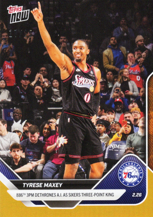 Tyrese Maxey in black 76ers jersey pointing skyward during game, surrounded by crowd, with card text and Philadelphia 76ers logo visible.