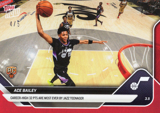 Ace Bailey rookie card showing overhead court view of player elevating for layup in black Jazz uniform with red foil border and stat text.