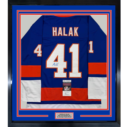 Framed blue New York Islanders hockey jersey number 41 signed by Halak with JSA authentication certificate visible.