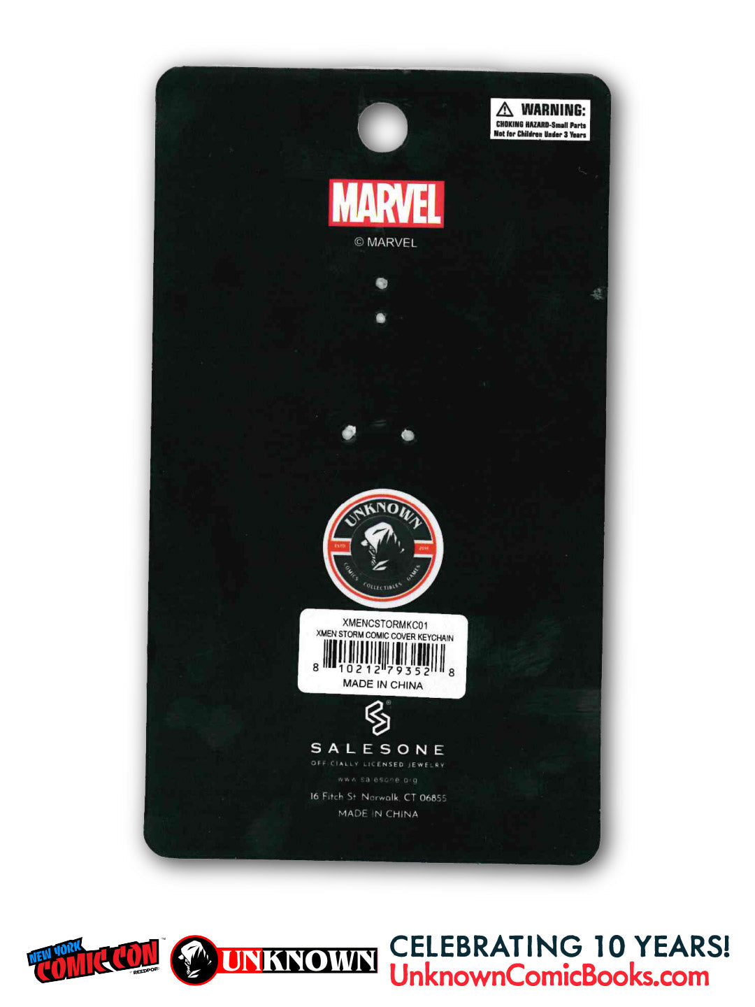 Back of a black card with a red Marvel logo, a warning label, and a white barcode sticker reading "XMEN STORM COMIC COVER KEYCHAIN.