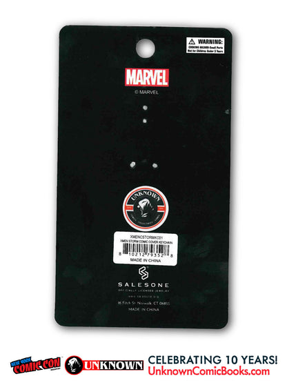 Back of a black card with a red Marvel logo, a warning label, and a white barcode sticker reading "XMEN STORM COMIC COVER KEYCHAIN.