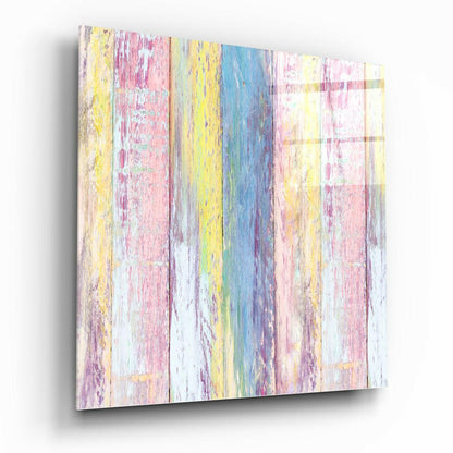 Angled perspective view of glass wall art featuring vertical wooden planks in pastel pink, yellow, blue, and white with distressed paint texture.