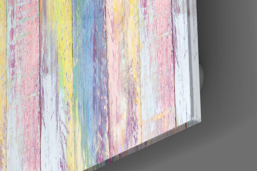 Angled perspective view of glass wall art with pastel rainbow-painted wooden planks in pink, yellow, blue, and white.