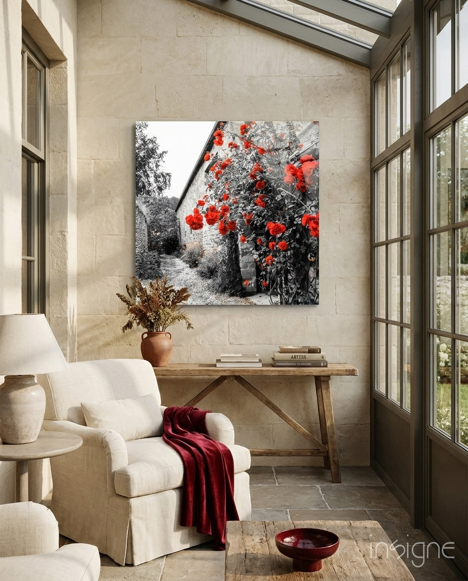 Red Roses Glass Wall Art displayed above wooden console table in cream stone sunroom with white armchair and burgundy throw.