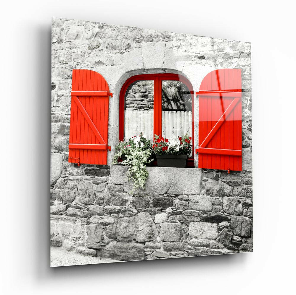 Red shutters and arched window with flowers on weathered stone wall, printed on glass panel.