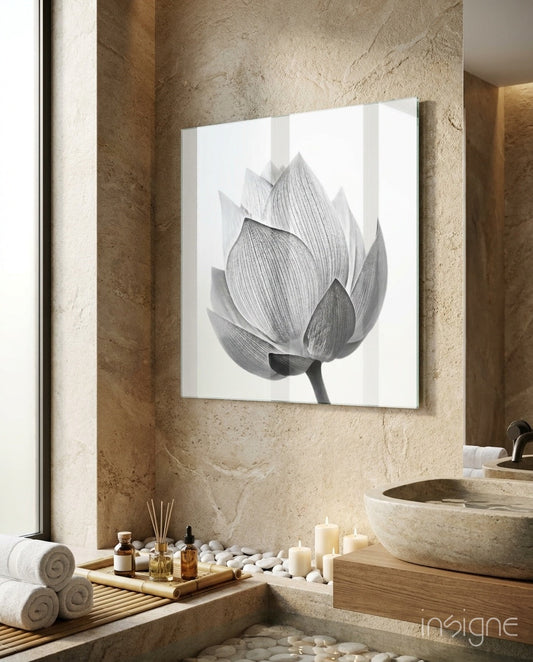 Silver lotus blossom glass wall art displayed in a spa bathroom with natural stone walls and spa accessories.