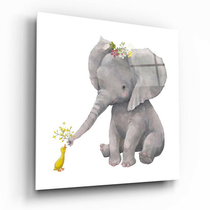 A gentle gray elephant holding yellow flowers offers them to a small yellow duck, both rendered in watercolor style on white glass.