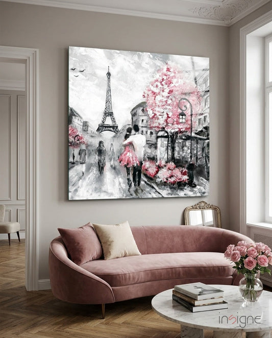 Pink and gray Paris street scene glass wall art hanging above a mauve curved sofa in a elegant room.