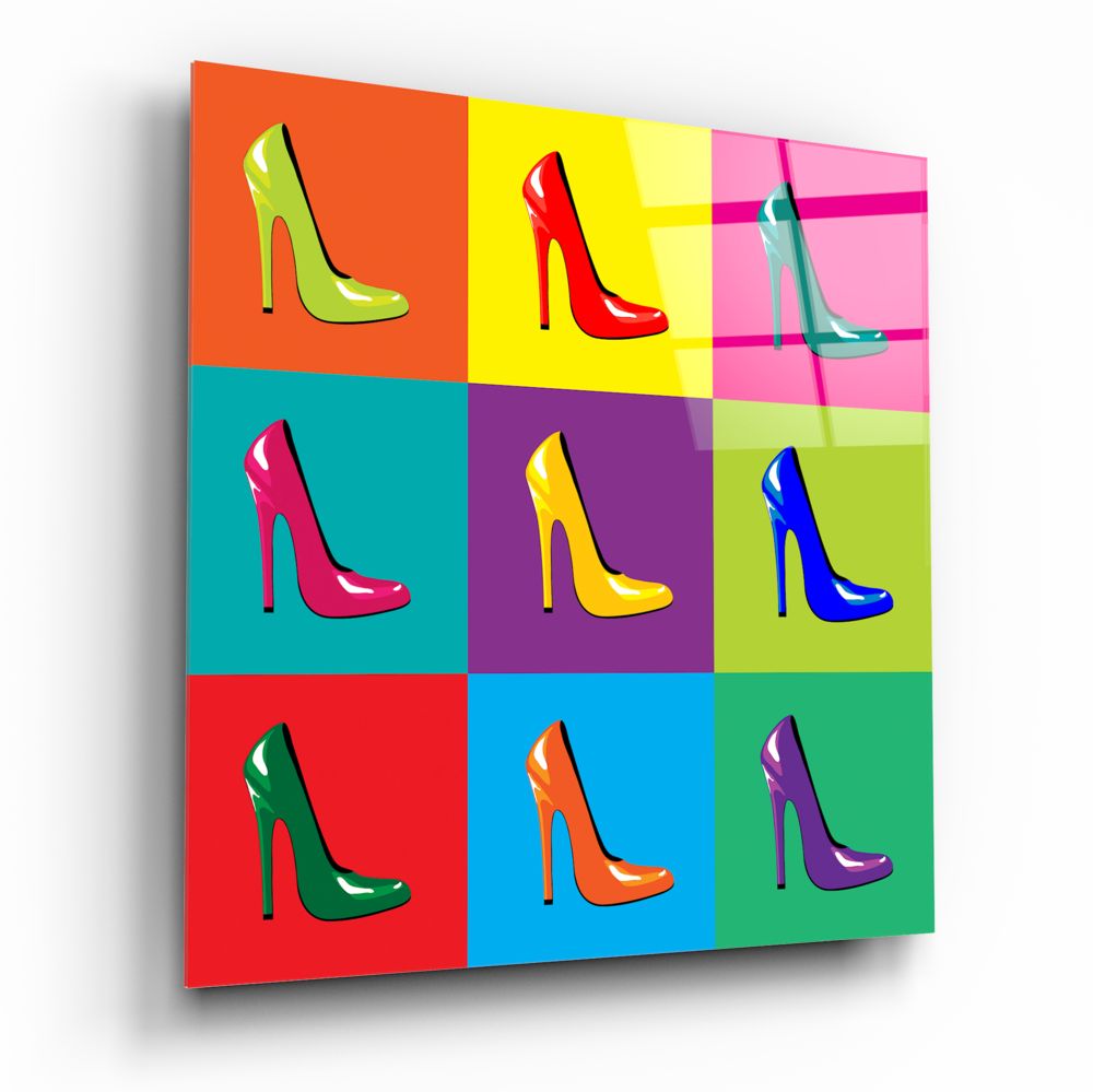 Pop art style glass wall art displaying nine colorful high-heeled shoes in different colors on a bright multi-colored grid background.