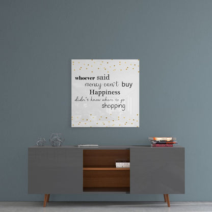 Glass wall art with gold polka dots displaying motivational shopping quote hangs above modern sideboard in styled room setting.