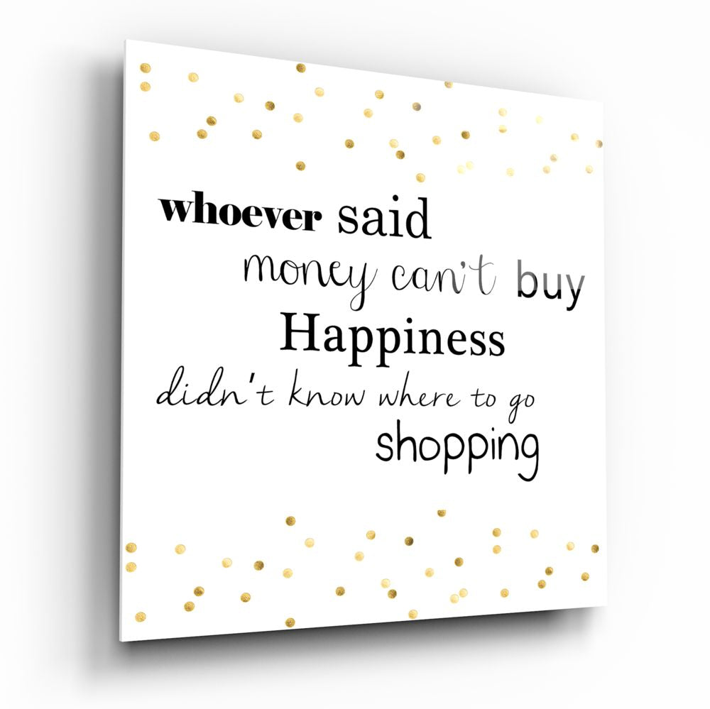 White glass wall art with black and gray text surrounded by gold polka dots, displaying a shopping quote in multiple font styles.