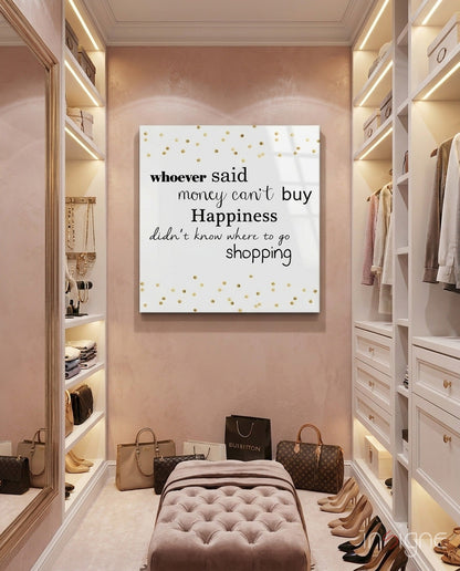 White glass wall art with gold polka dots and black text displayed in a pink luxury closet with built-in shelving and handbags.