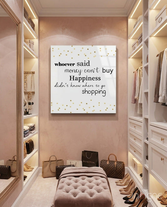 White glass wall art with gold polka dots and black text displayed in a pink luxury closet with built-in shelving and handbags.