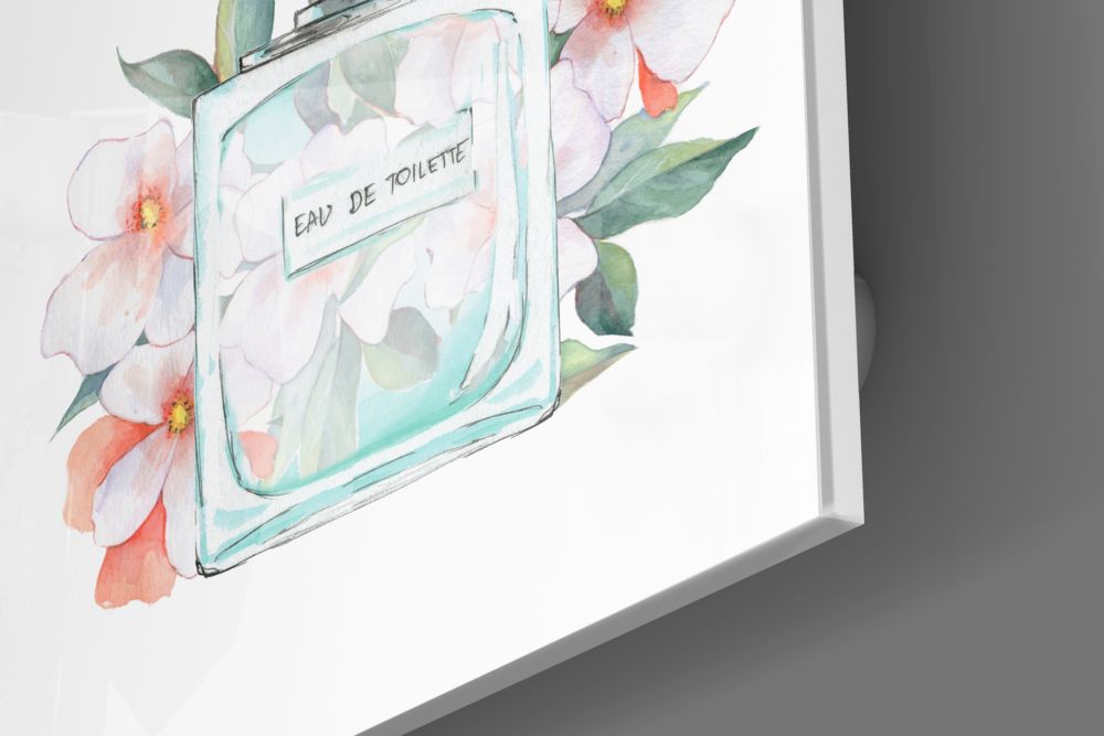 Angled view of glass wall art featuring a turquoise perfume bottle with "Eau De Toilette" label surrounded by watercolor pink and coral flowers with green leaves.